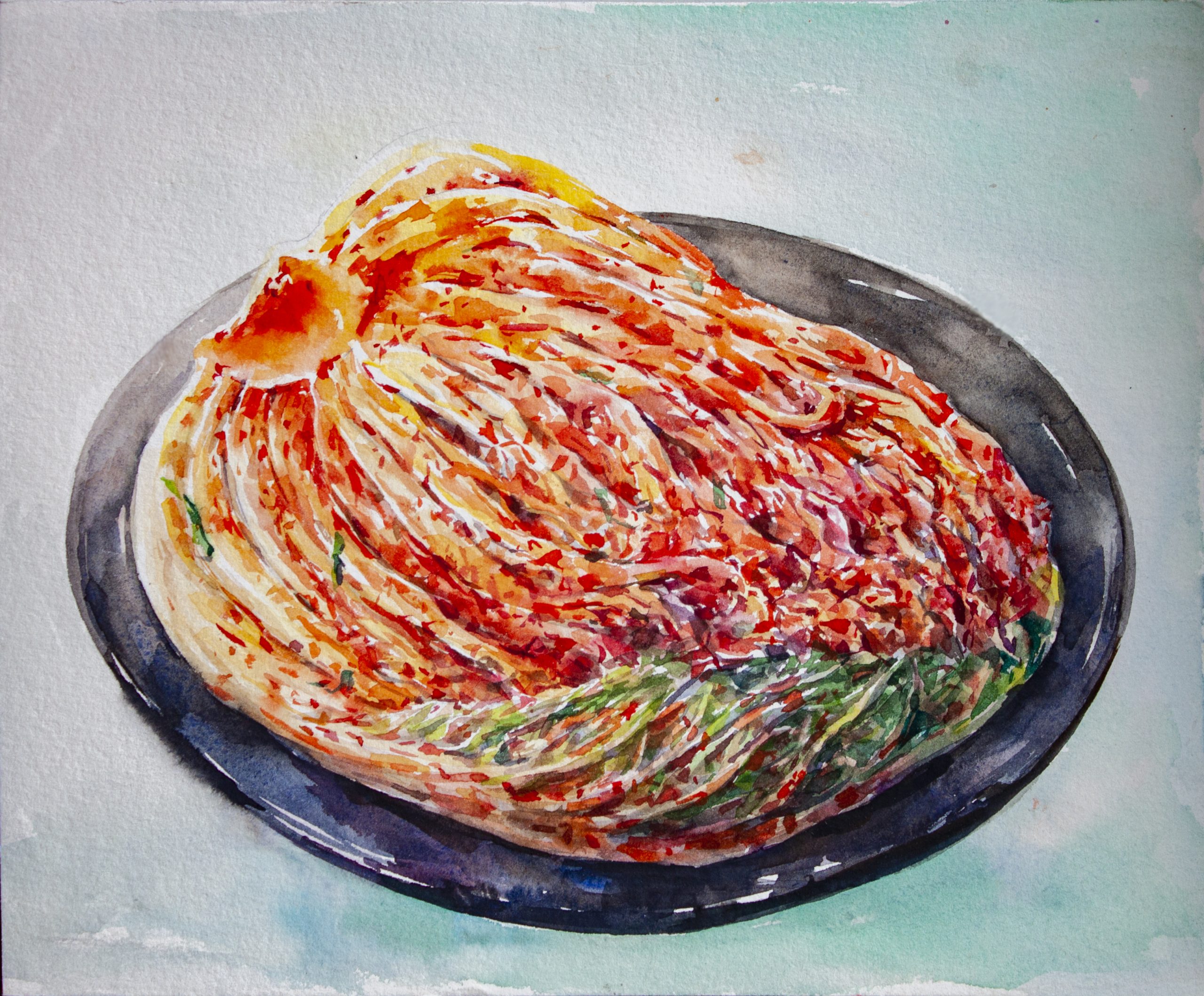 A glistening half of a kimchi napa cabbage head is displayed in a round black ceramic dish. The background is a wash of turquoise watercolor paint.